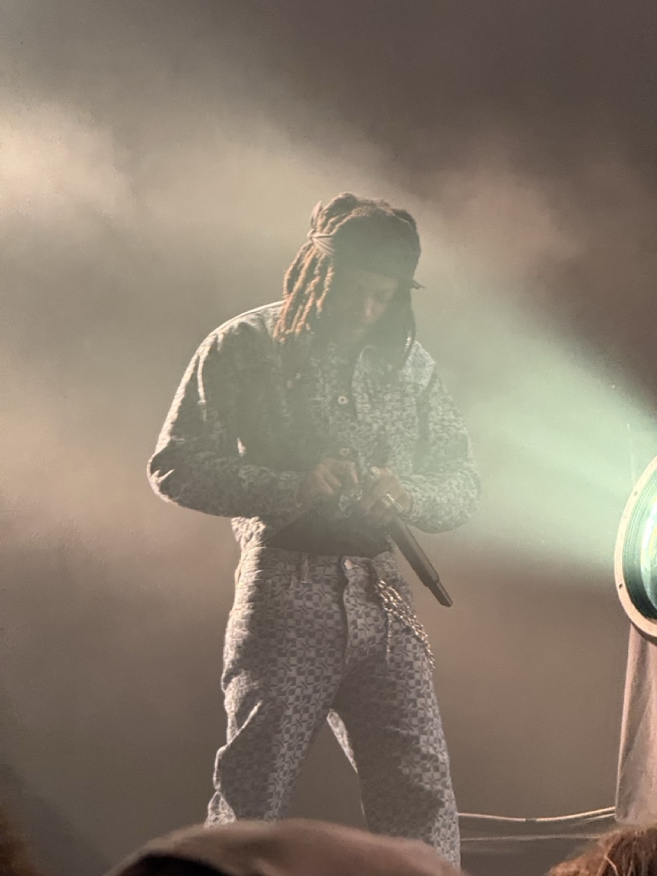 JID shrouded in smoke on stage.