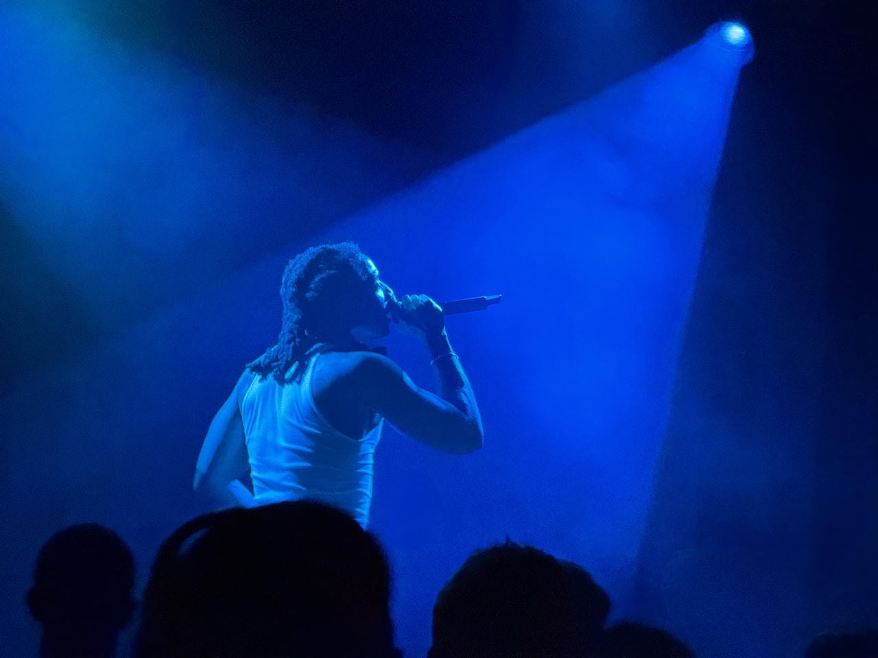 Kenny Mason performing on stage.