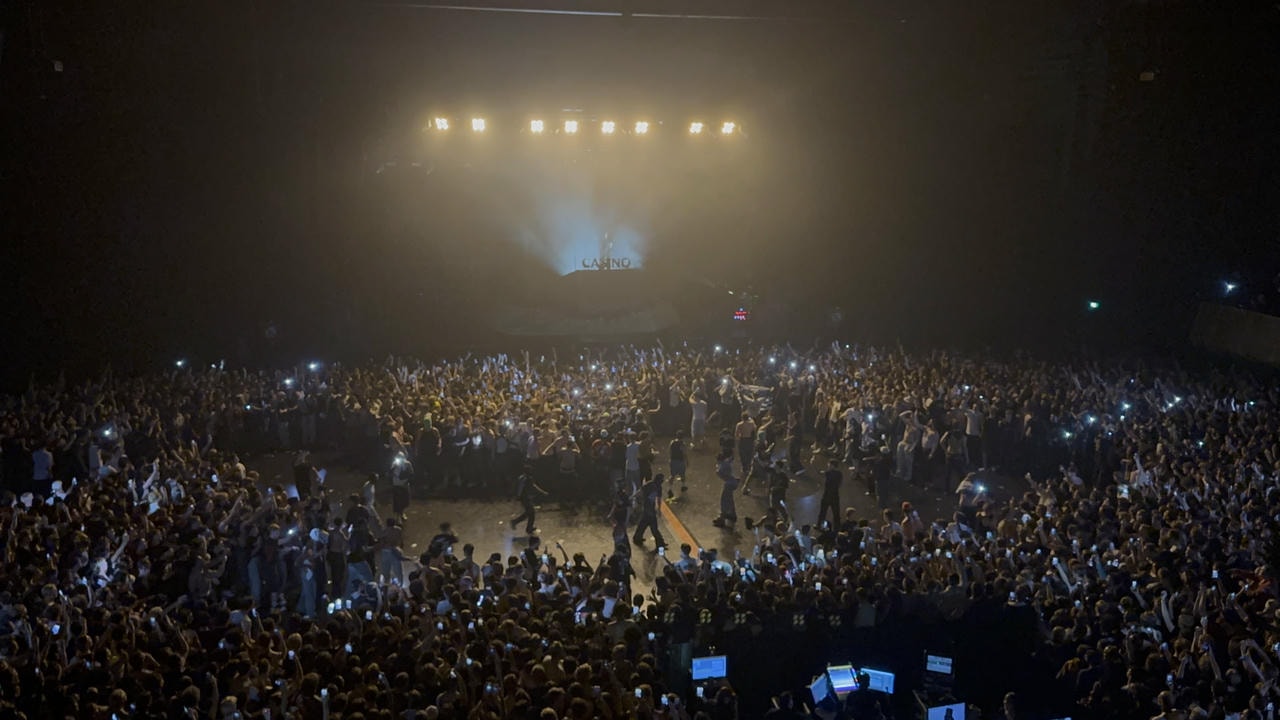 The crowd at a concert, seen from the balcony. A massive mosh pit is opened up in the middle while we waited for 'family ties' to start.